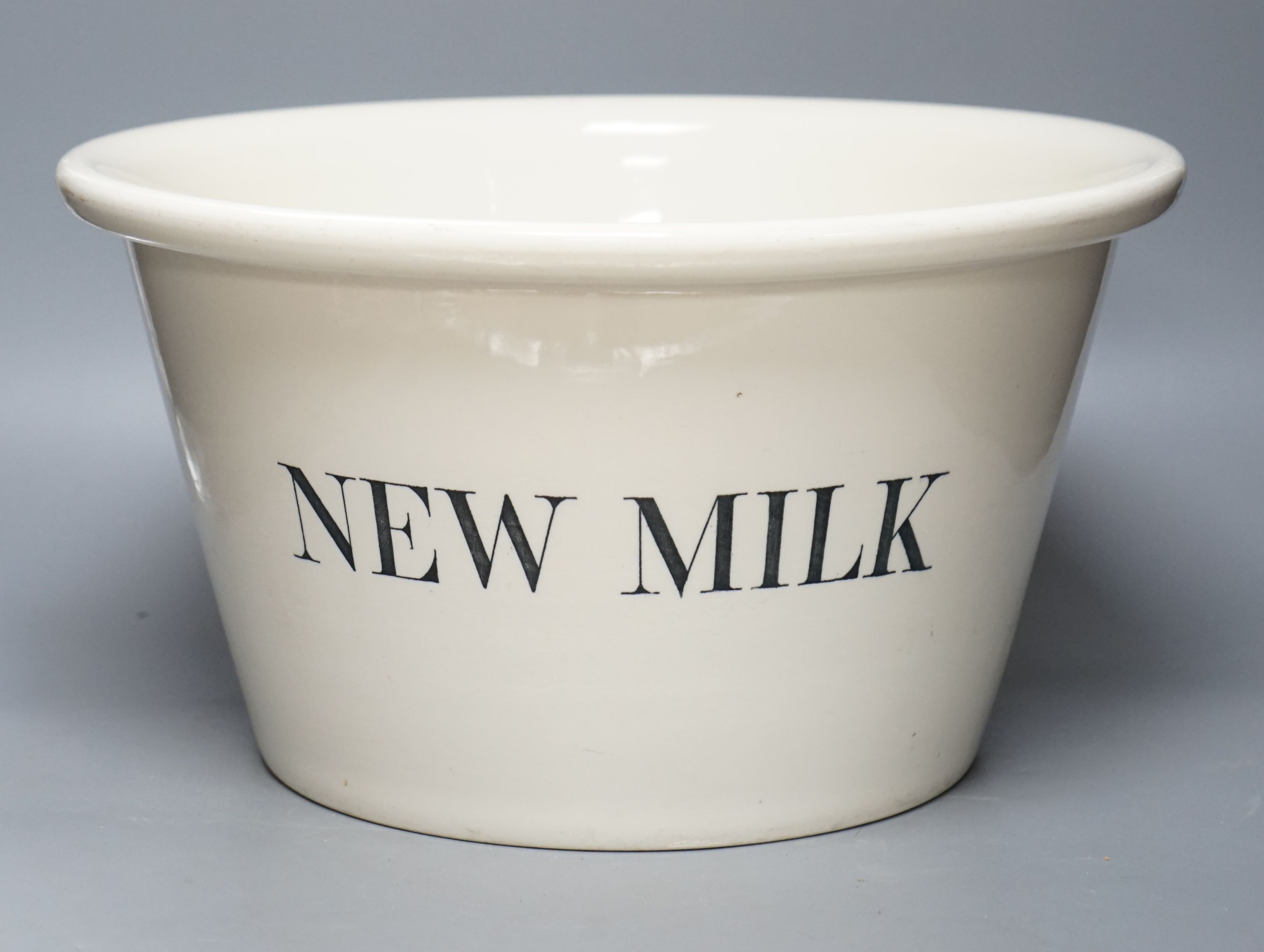 A large 'New Milk' creamware dairy bowl by Dairy Supply Co. Limited, Museum Street, London 39cm